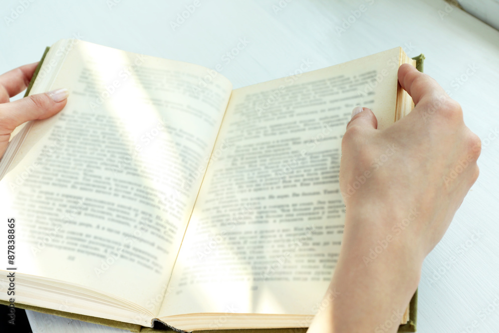 Obraz premium Woman reading book near window