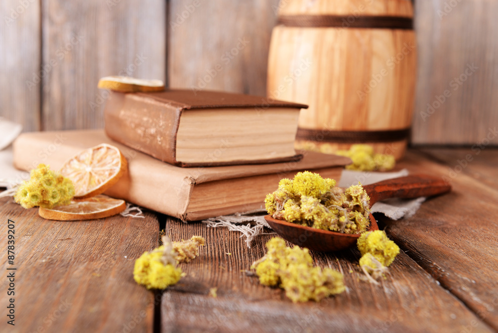 Old books with dry flowers and lemon on table close up Old books with dry flowers and lemon on table close up