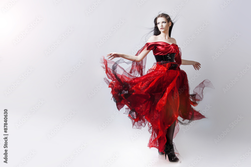 Fashion photo of young magnificent woman in red dress. Studio Fashion photo of young magnificent woman in red dress. Studio