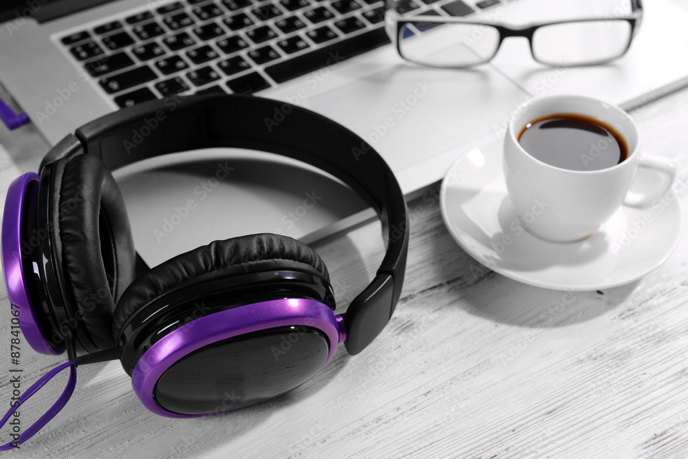 Workplace with headphones on table close up Workplace with headphones on table close up