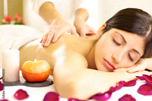 Beautiful woman receiving relaxing massage in spa