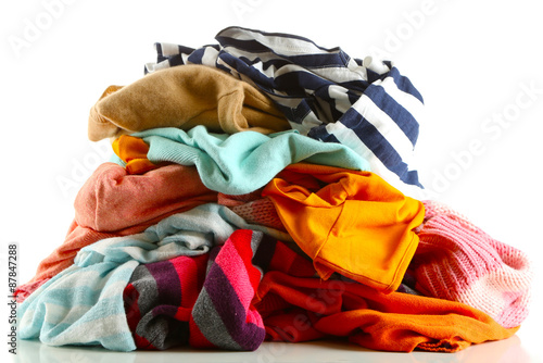 Heap of different clothes, isolated on white © Africa Studio