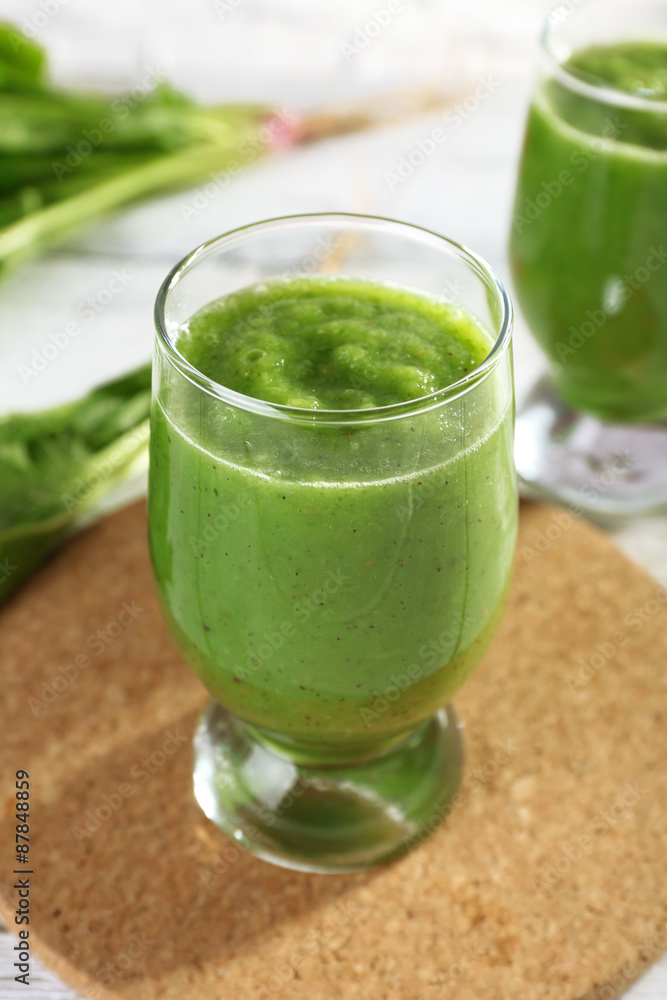 Healthy green smoothie with spinach on wooden table, closeup Healthy green smoothie with spinach on wooden table, closeup