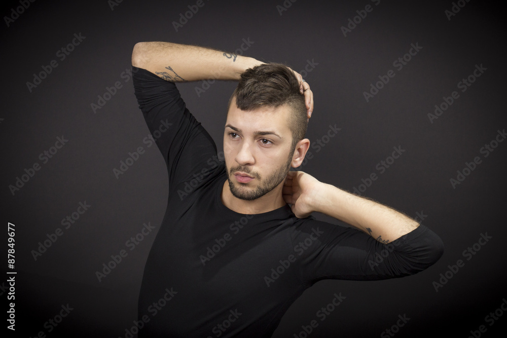 Male dancer posing. Black background.