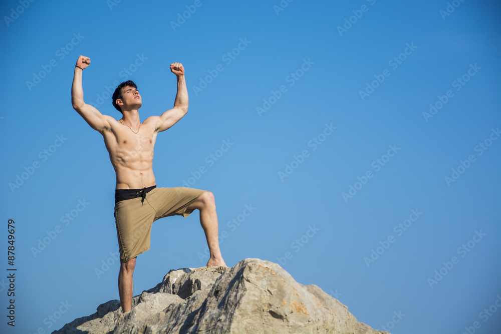 Successful sexy muscular shirtless man with fists raised Successful sexy muscular shirtless man with fists raised