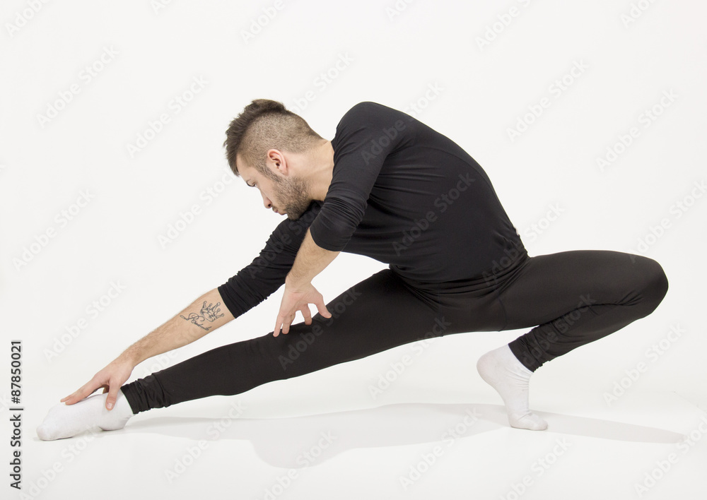 Male dancer practising , arm extented, legs extended. Male dancer practising , arm extented, legs extended.