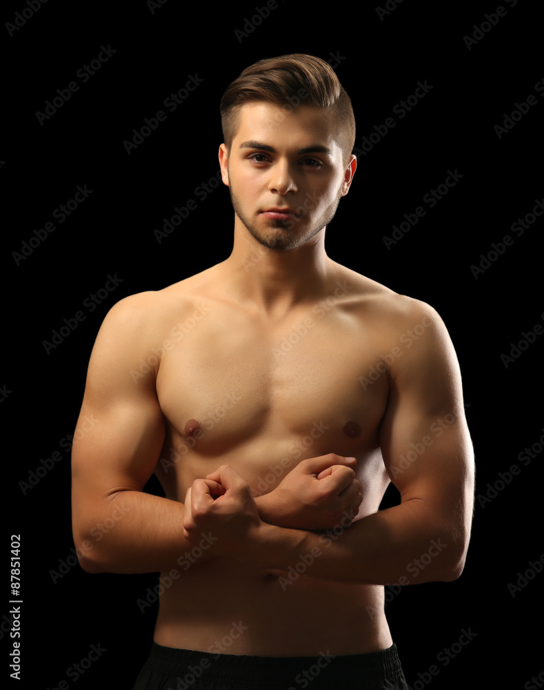 Fototapeta premium Muscle young man on dark background