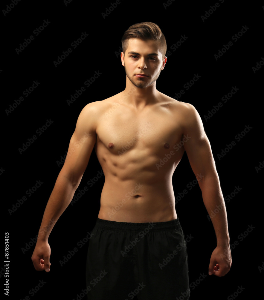 Fototapeta premium Muscle young man on dark background