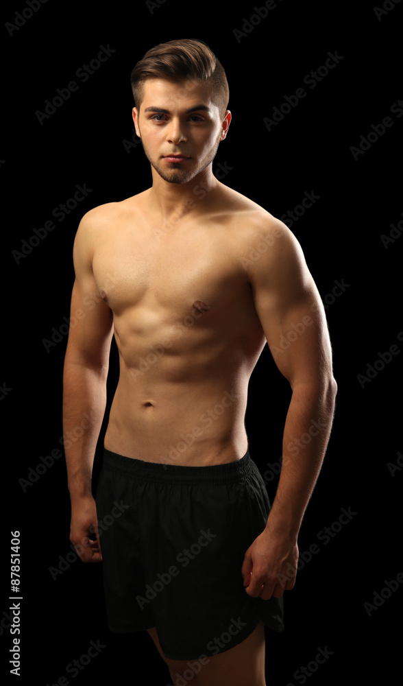 Muscle young man on dark background Muscle young man on dark background