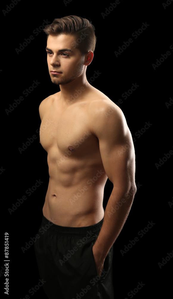 Muscle young man on dark background