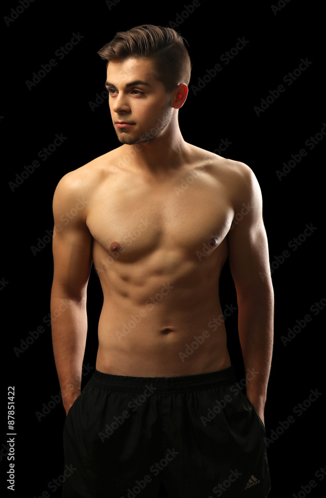 Muscle young man on dark background