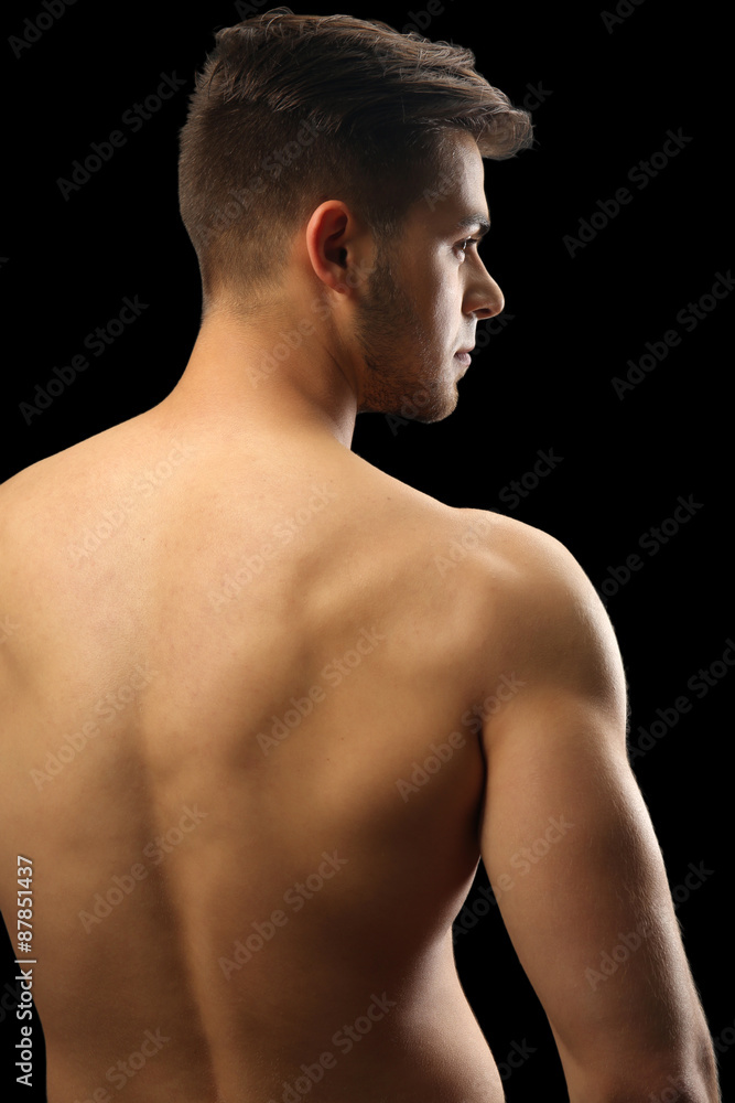 Fototapeta premium Muscle young man on dark background