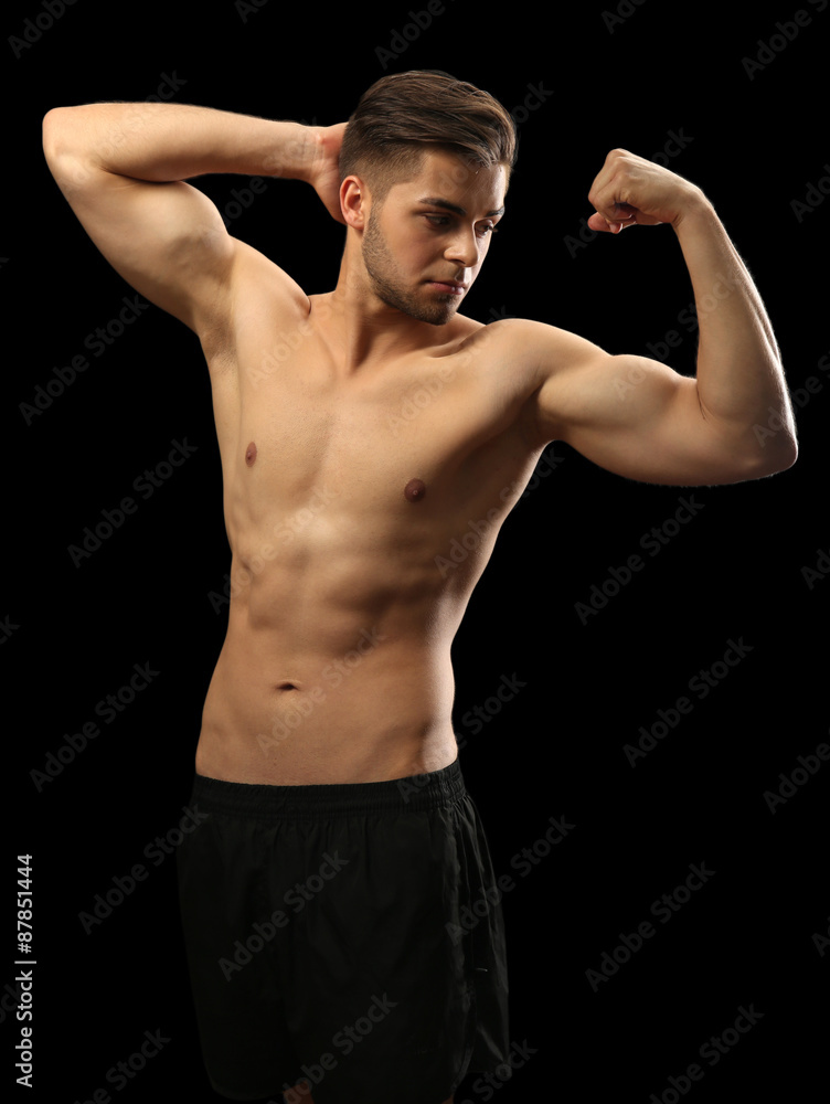 Muscle young man on dark background
