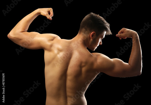 Muscle young man on dark background