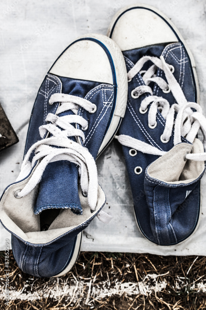 second hand fabric navy blue sneakers on sale at garage sale on grass for  donation, recycling or selling for cheap to cope with over-consumption and  fashion Stock Photo | Adobe Stock