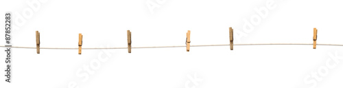 Old wooden clothespins on a rope isolated