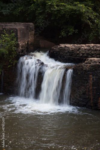 Mountain water cascading by rocks