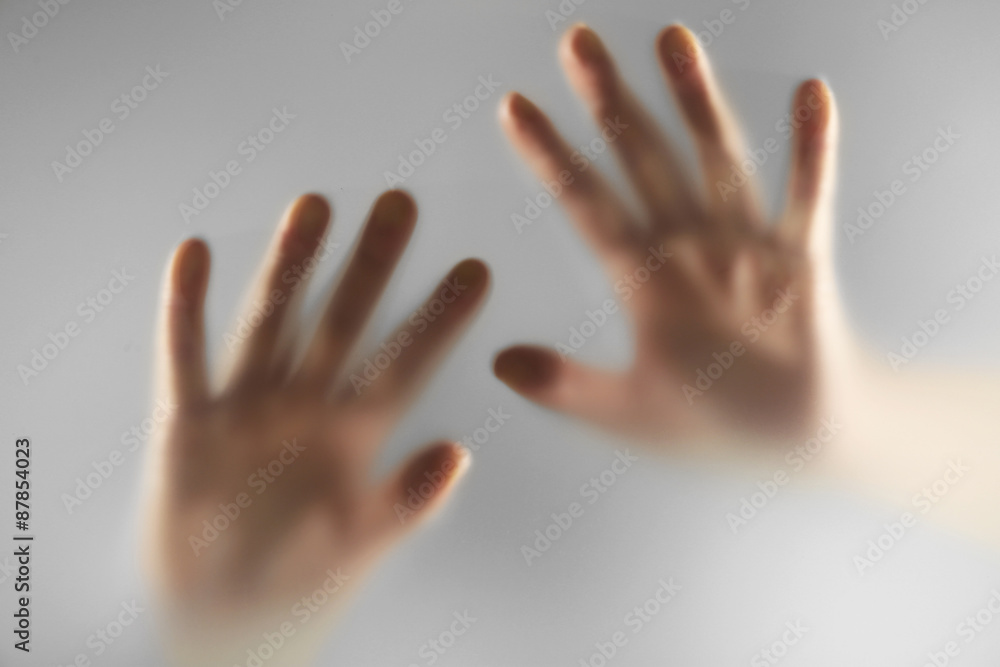 Hands silhouettes behind glass foreground Hands silhouettes behind glass foreground