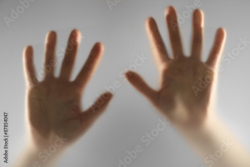 Hands silhouettes behind glass foreground