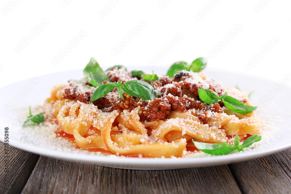 Pasta Bolognese with parmesan and basil on light background Pasta Bolognese with parmesan and basil on light background