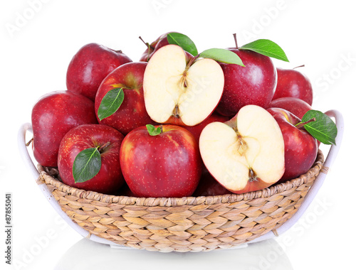 Ripe red apple in wicker basket isolated on white