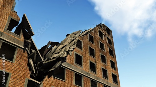 Fényképezés Ruined brick apartment building against blue sky close up