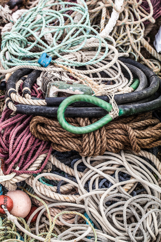 closeup of old ropes for boat and sailing equipment with buoys and rubber rings sold at flea market or garage sale for collections