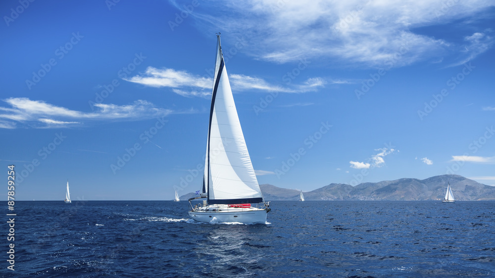 Sailing boats with white sails in the Sea. Luxury ship yachts...