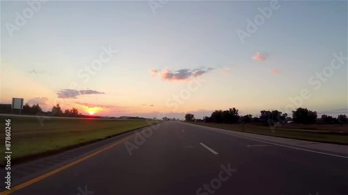 Time-lapse of driving down a highway at sunset
