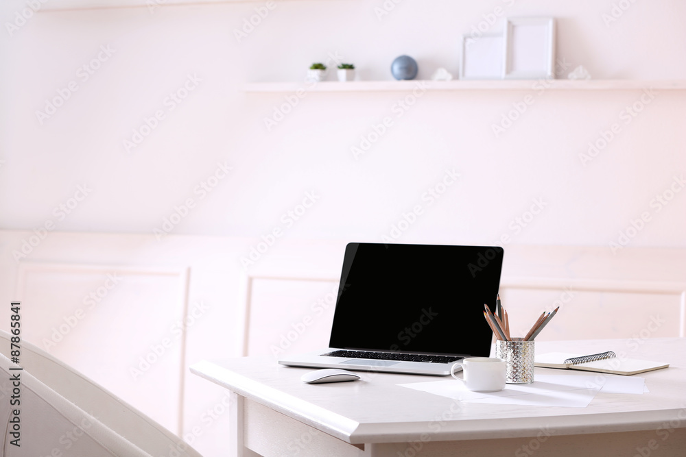 Workplace with laptop in room Workplace with laptop in room