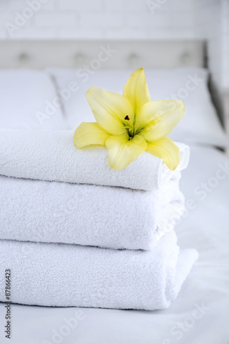 Freshly laundered fluffy towels in bedroom interior