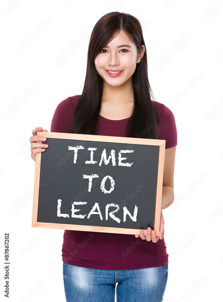 Asian woman with chalkboard showing phrase time to learn Asian woman with chalkboard showing phrase time to learn