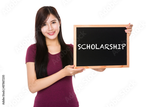 Asian woman hold with the blank chalkboard showing a word schola photo