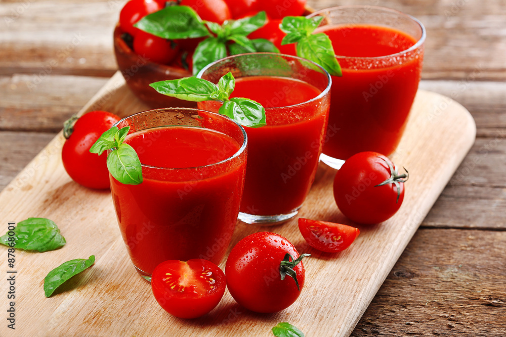 Glasses of tomato juice on wooden table, closeup Glasses of tomato juice on wooden table, closeup