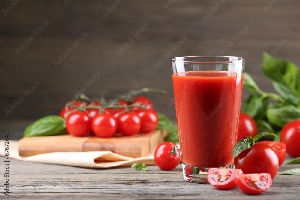 Glass of tomato juice with vegetables on wooden table close up Glass of tomato juice with vegetables on wooden table close up
