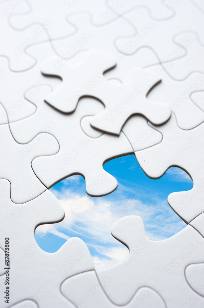 Jigsaw piece with sky in hole, conceptual image Jigsaw piece with sky in hole, conceptual image