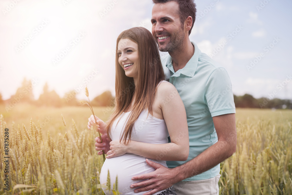 Cute couple standing on the grain field Cute couple standing on the grain field