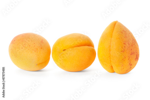 three apricot fruits isolated on white background