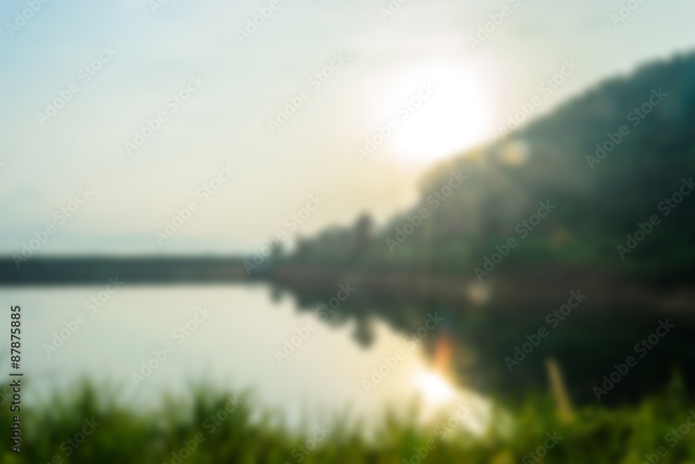 blurry landscape with lake at sunrise