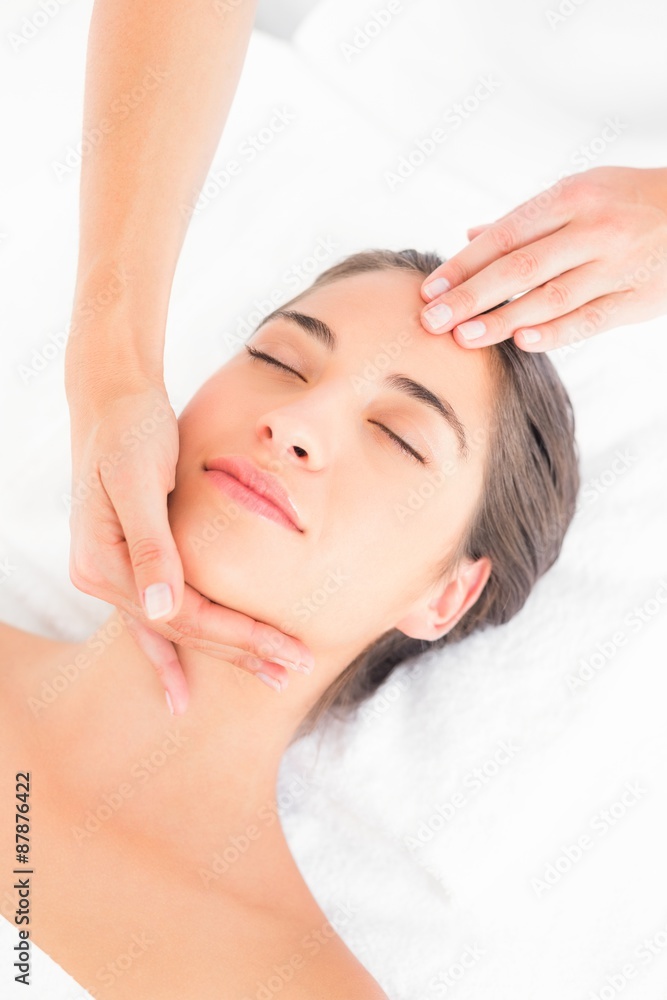 Attractive woman receiving head massage at spa center Attractive woman receiving head massage at spa center