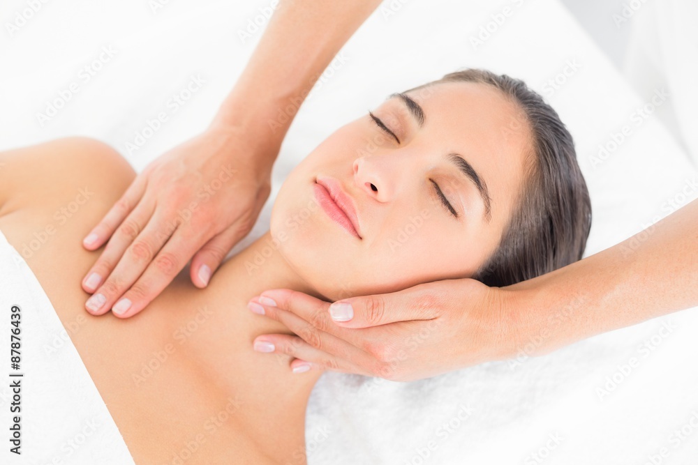 Attractive woman receiving head massage at spa center Attractive woman receiving head massage at spa center