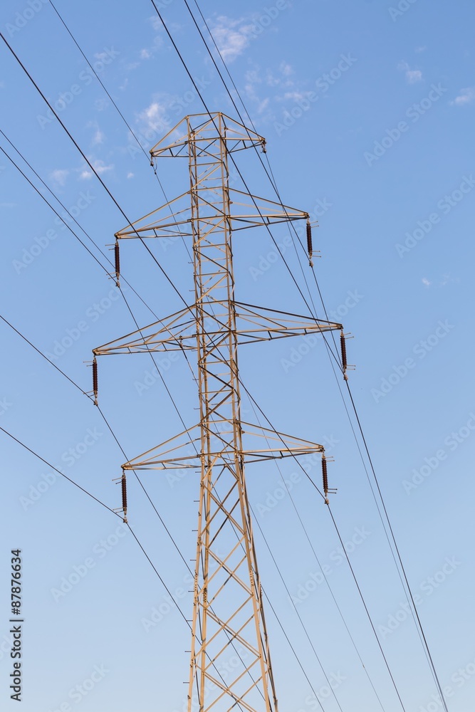 Power pole and power lines on blue sky background