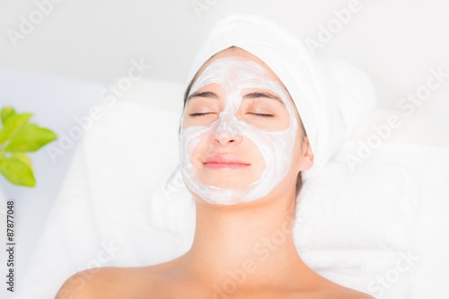 Attractive woman having white cream on her face 