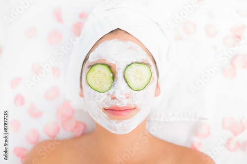 Attractive woman having cucumber on her face