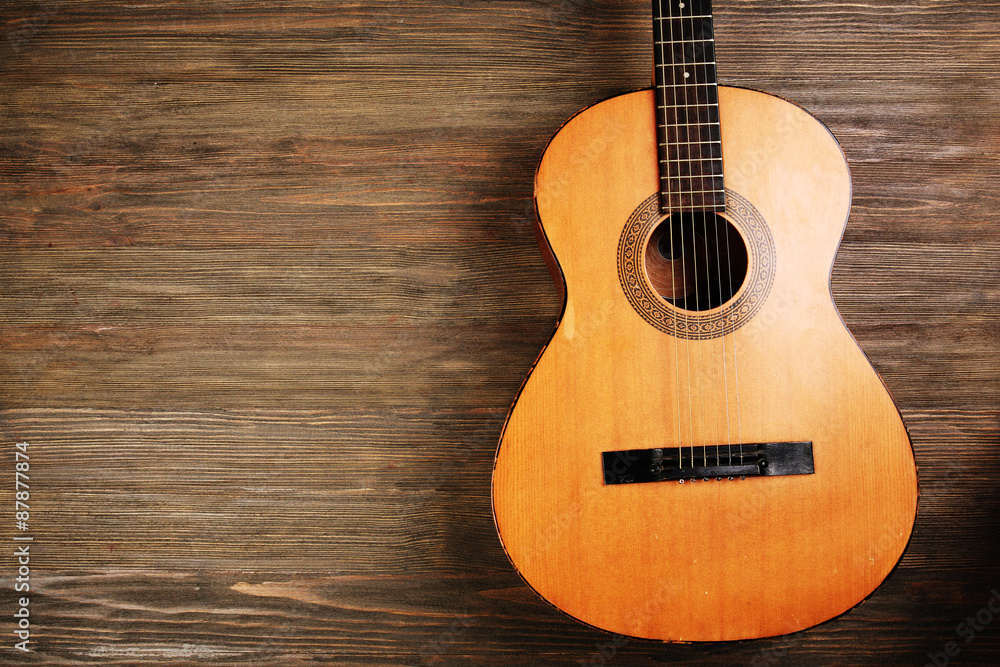Fototapeta premium Acoustic guitar on wooden background