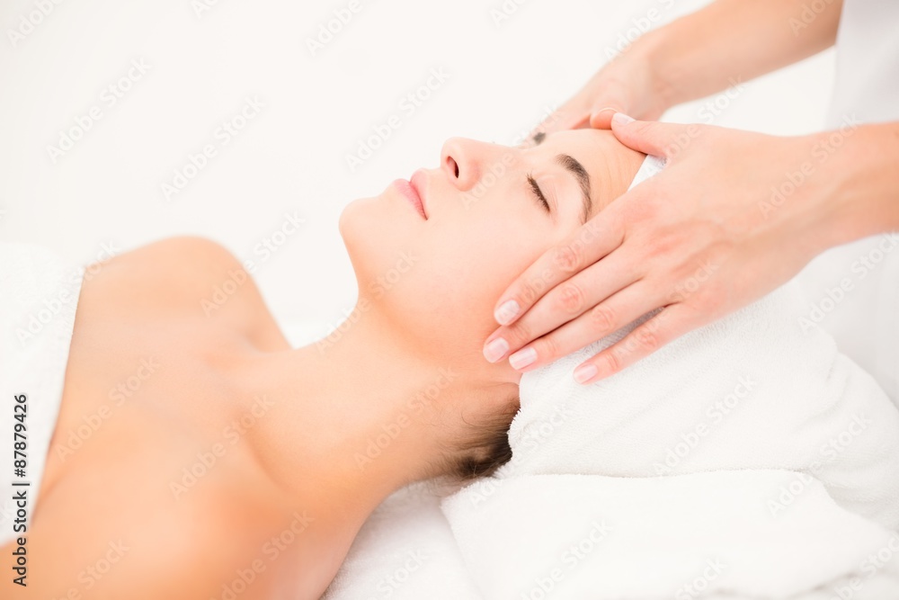 Attractive woman receiving facial massage at spa center Attractive woman receiving facial massage at spa center