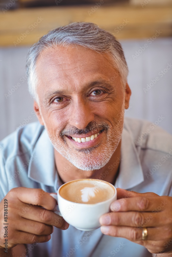 Man sitting in cafe having coffee Man sitting in cafe having coffee