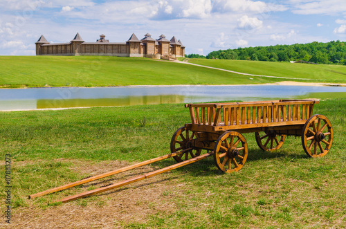 old wooden wagon on old castle backgrounds photo