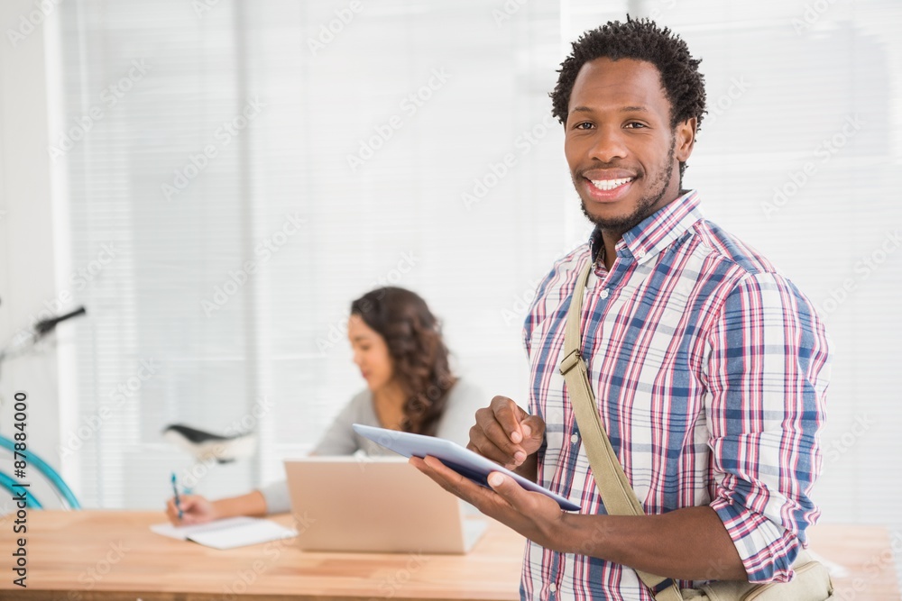 Young businessman smiling at the camera Young businessman smiling at the camera