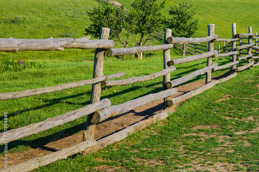 old rural wooden fence on green grass backgrounds